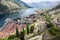 Panoramic view of the Kotor Gulf or Boka Kotorska with medieval town, sea port with ferryboats and surrounding mountains. View