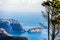 Panoramic view of La Nao cape in Javea, Spain. A tree and a streetlamp in the foreground.