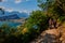 Panoramic view on Lake Garda from the Busatte-Tempesta trail near Nago-Torbole with the iron staircase,  Torbole  town surrounded