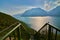 Panoramic view on Lake Garda from the Busatte-Tempesta trail near Nago-Torbole with the iron staircase,  Torbole  town surrounded