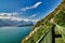 Panoramic view on Lake Garda from the Busatte-Tempesta trail near Nago-Torbole with the iron staircase,  Torbole  town surrounded