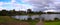 Panoramic view of a lake a park in broadmeadows Melbourne Victoria surrounded by lush green trees