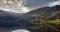 A panoramic view of the lake in Voss Norway, the water is still mirrored and the sun shines down in the evening