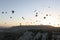 Panoramic view landscape with hot air balloons, sunrise and mountains on background