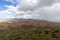 Panoramic view at landscape from viewpoint Mirador Morro Velosa on Fuerteventura with  green vegetation and multi colored volcanic