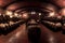 panoramic view of a large wine cellar with rows of barrels
