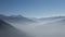 A panoramic view of layers of mountains with fog