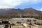 The panoramic view of Lhasa city, in front of Potala Palace and Palace square, with modern building and mountains, far away a Tib