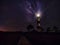 Panoramic view of Lighthouse and Milky Way galaxy at night