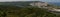 Panoramic view of a limestone quarry, city blocks and the territory of a building materials plant on the banks of the Volga River.