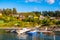 Panoramic view of Lindoya island on Oslofjord harbor near Oslo, Norway, with Lindoya Vest marina and summer cabin houses at