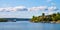 Panoramic view of Lindoya island on Oslofjord harbor near Oslo, Norway, with summer cabin houses at wooded shoreline in early