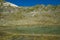 Panoramic view of little alpine lake near the refuge of Giogo Lungo