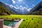 Panoramic view Logarska valley, Slovenia with pond and sunchairs in front