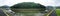 Panoramic view looking across a Cornish river towards woodland