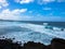 Panoramic view of Los Hervideros. Rugged volcanic coast, strong surf, sea caves, red lava hills. Lanzarote, Canary Islands, Spain