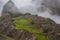 Panoramic view of Machu Picchu in mist, Peru.