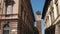 Panoramic view of Majestic clock tower between eclectic palaces in Pavia, Italy