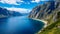 Panoramic View of a majestic Fjord with steep Cliffs and deep blue Water