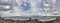 Panoramic view of a man on a rocky beach with Stunning storm Cumulus clouds and waves in the Aegean on a summer day in Evia island