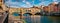 Panoramic view of medieval arched river bridge with Roman origins - Ponte Vecchio over Arno river. Colorful summer cityscape of Fl