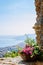 Panoramic view of a Mediterranean bay from a stone arch of a medieval village in the Ligurian Riviera, Borgio Verezzi, Liguria,