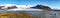 Panoramic view of melting icebergs floating in the Fjallsarlon glacial lake with Fjallsjokull glacier calving into lagoon in