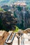 Panoramic view from Meteoron Monastery cliff stone stairs with metal railings on scenic Meteora landscape rock formations with