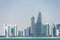 Panoramic view of modern skyline of Doha through the blue water. Concept of wealth and luxury