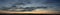 Panoramic view of the morning sky and clouds in the rays of the dawn sun