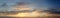 Panoramic view of the morning sky and clouds in the rays of the dawn sun.