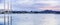 Panoramic view of Morro Bay harbor at sunset; sea otters floating on the calm waters; Morro bay, California