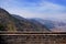 Panoramic view of mountain peaks and a village from the Mutianyu section of the Great Wall of China, surrounded by