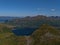 Panoramic view of mountain range in the north of AustvÃ¥gÃ¸ya, Lofoten, Norway with the blue colored water of fjord.