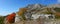 Panoramic view of the mountain range, rocks and trees, bright autumn colors.