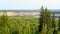 Panoramic view from the mountain to the turn of the Northern Yakut river Viluy among the steep banks of hills.