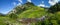 Panoramic view of a mountain valley, summer greens and mountain stream