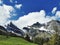 Panoramic view of mountaintops against cloudy sky