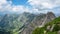 Panoramic view from Nebelhorn in Oberstdorf AllgÃ¤u Bavaria Germany - Beautiful Alps with lush green meadow and blue sky -