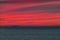 Panoramic view of the ocean sunset against the background of multi-colored stratus clouds. Natural background for abstract