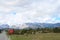 Panoramic view with old rural houses from the beautiful green plateau of Zabljak mountain to the snowy Durmitor mountain