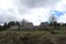 Panoramic view with old rural houses from the beautiful green plateau of Zabljak mountain to the snowy Durmitor mountain