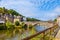 panoramic view of old stone bridge and historical medieval houses reflecting in La Rance river in Dinan town port