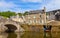 panoramic view of old stone bridge and historical medieval houses reflecting in La Rance river in Dinan town port
