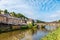 panoramic view of old stone bridge and historical medieval houses reflecting in La Rance river in Dinan town port