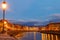 Panoramic view of the old town of Pisa and the Arno river at twilight, Italy