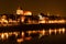 Panoramic view of old town of Torun at night reflected with many