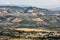 Panoramic view of olive groves and farms on rolling hills of Abruzzo.