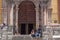 Panoramic view of one of the entrances of the basilica collegiate church of Our Lady of Guanajuato with two teenagers talking and