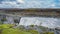 Panoramic view over biggest and most powerful waterfall in Europe called Dettifoss in Iceland, near lake Myvatn, with many